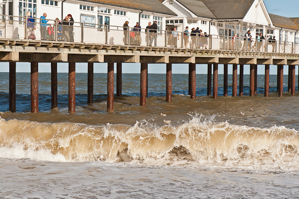 Southwold Pier, waves and holiday makers (Suffolk)