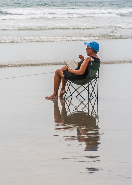 A woman reading on the beach, Cape Canaveral