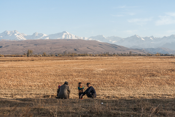 Kyrgyz men and children relaxing in the sun