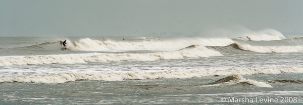 Surfers taking advantage of an off-shore hurricane (Florida)